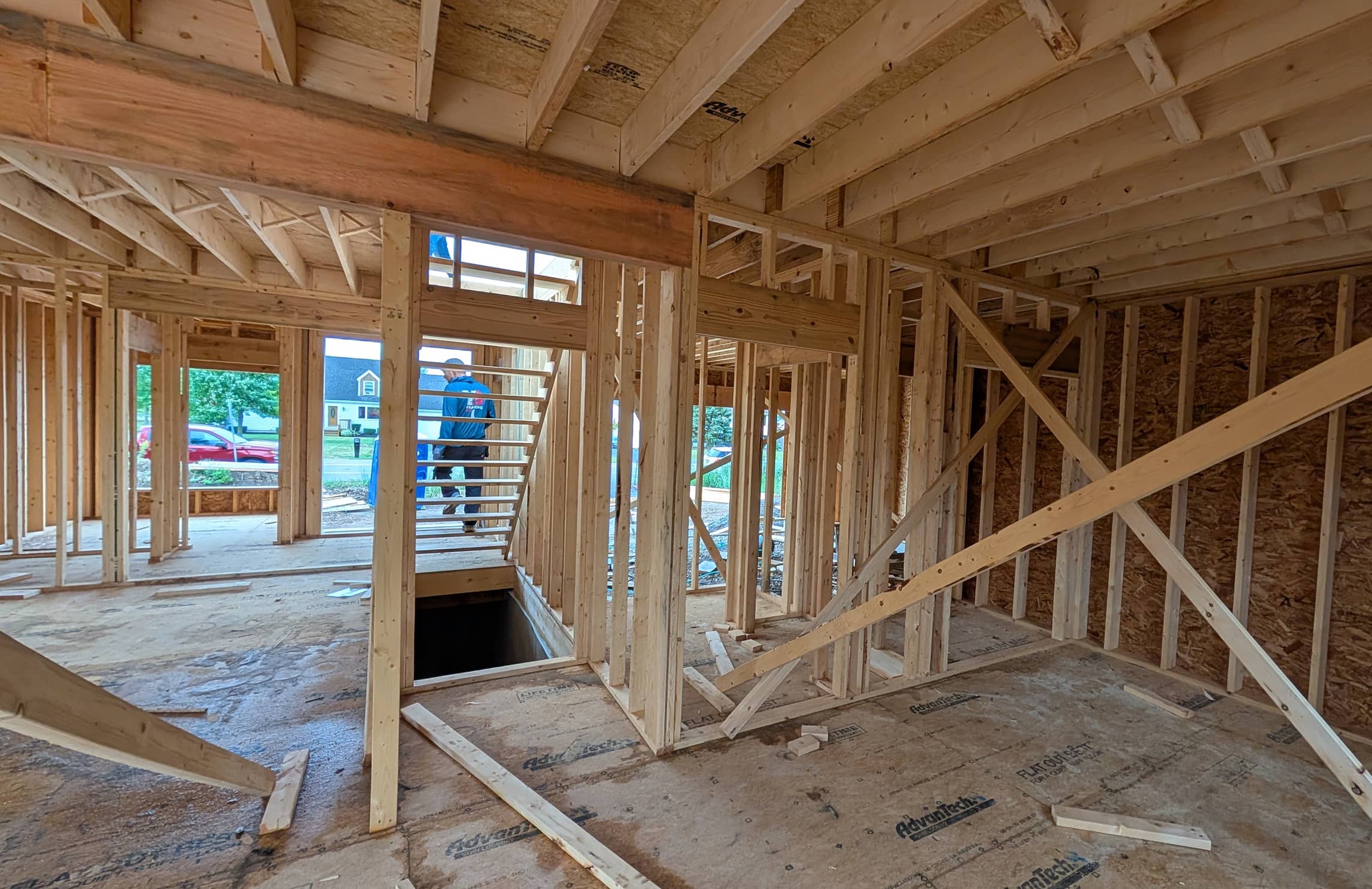 A home interior under construction with visible wooden beams